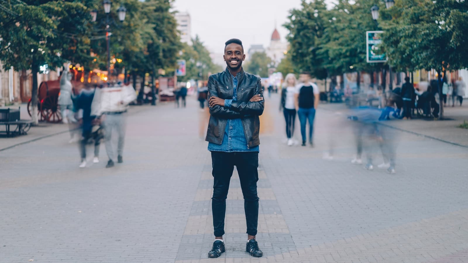 A smiling local confidently standing on a busy city street