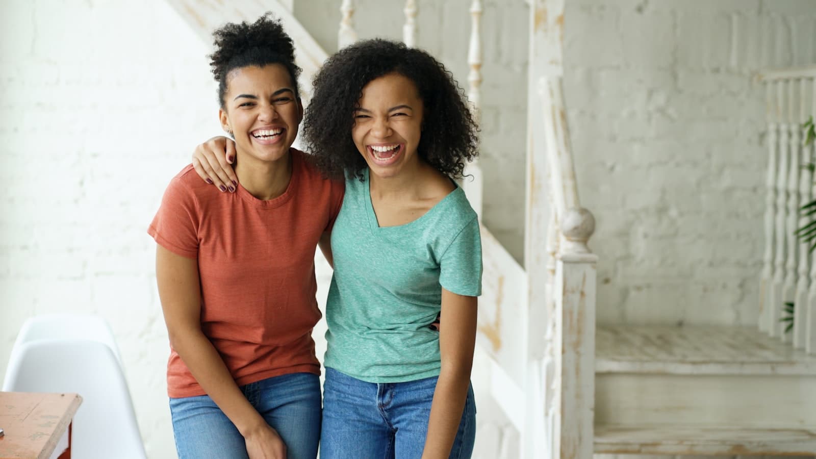 Two women laughing together during a candid conversation