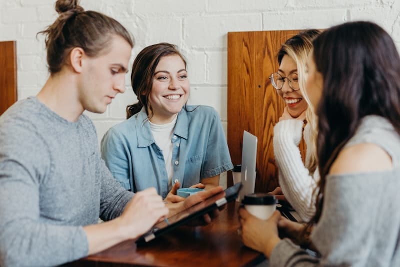 Friends laughing together over coffee